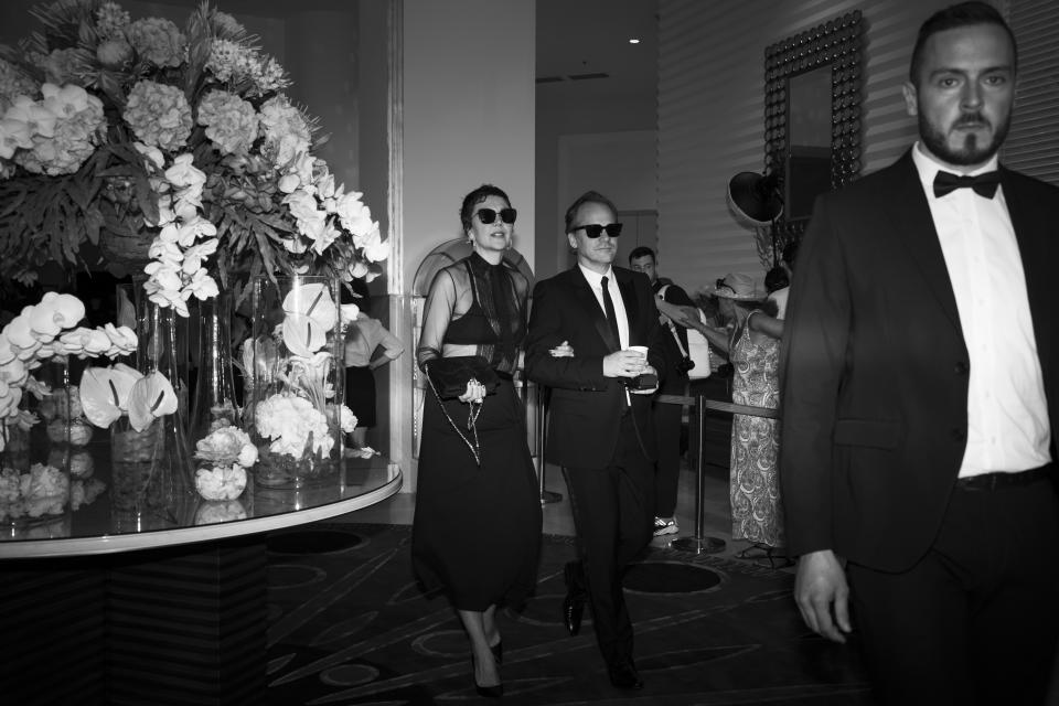 Maggie Gyllenhaal, left, and Peter Sarsgaard leave the Martinez hotel prior to attending the premiere of the film 'The Innocent' at the 75th international film festival, Cannes, southern France, Tuesday, May 24, 2022. (AP Photo/Petros Giannakouris)