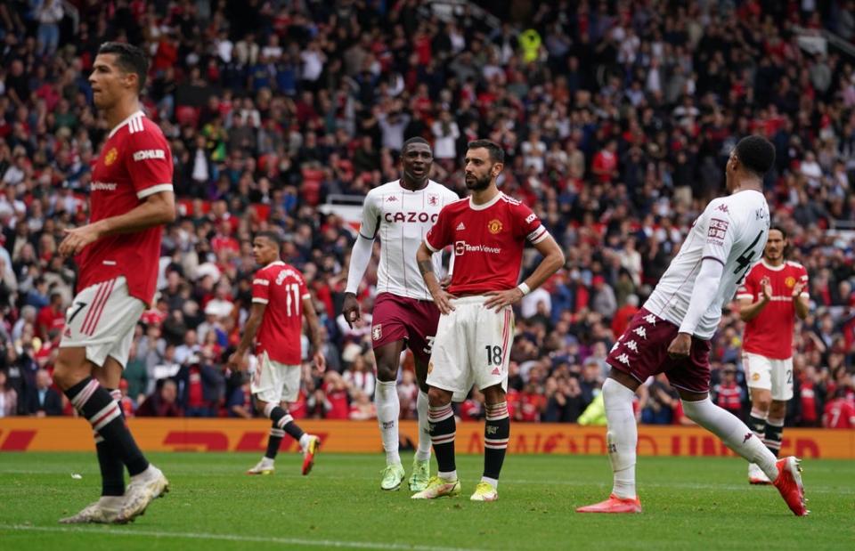 Bruno Fernandes, centre, reacts after missing a late penalty as Cristiano Ronaldo, left, looks on (Martin Rickett/PA) (PA Wire)