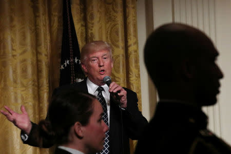 U.S. President Donald Trump hosts a reception for Senators and their spouses at the East Room of the White House in Washington, U.S., March 28, 2017. REUTERS/Carlos Barria