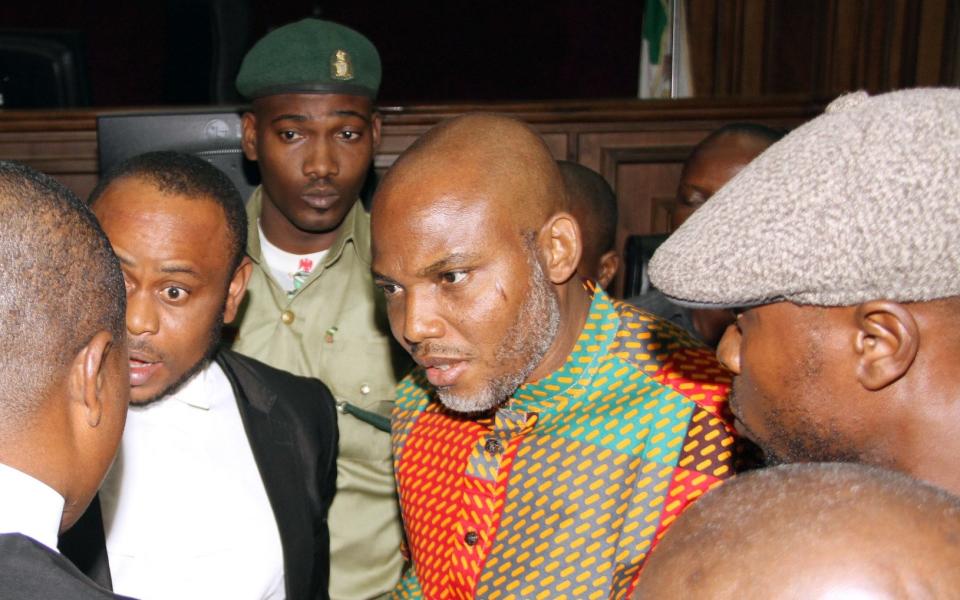 Biafran separatist leader Nnamdi Kanu, center, speaks to his lawyers at the Federal High court in Abuja, Nigeria Friday, Jan. 29, 2016 - AP