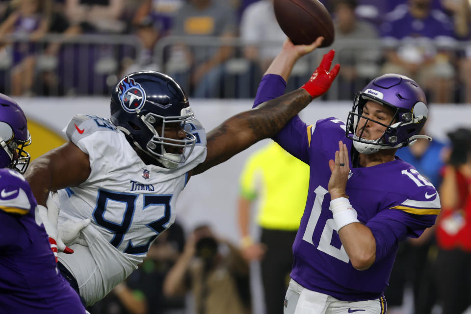 Minnesota Vikings quarterback Nick Mullens (12) attempts to throw a pass under pressure from Tennessee Titans defensive tackle Teair Tart (93) in the first half of a preseason NFL football game, Saturday, Aug. 19, 2023, in Minneapolis. (AP Photo/Bruce Kluckhohn)