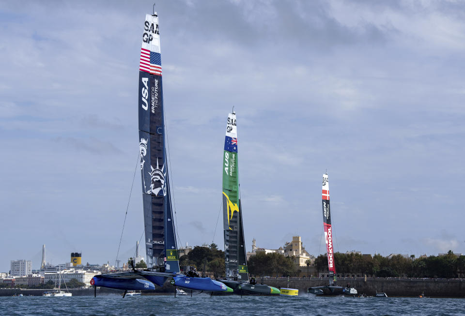 In this image provided by SailGP, USA SailGP Team helmed by Jimmy Spithill leads Australia SailGP Team helmed by Tom Slingsby and ROCKWOOL Denmark SailGP Team helmed by Nicolai Sehested on Race Day 2 of the Spain Sail Grand Prix in Cadiz, Spain., Sunday, Oct 15 2023. (Bob Martin/SailGP via AP)