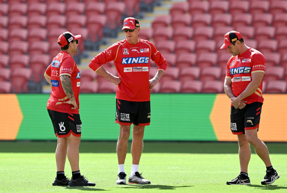 BRISBANE, AUSTRALIA - MARCH 23: Coach Wayne Bennett is seen chatting with Assistant Coaches Kristian Woolf (R) and Nathan Fien during a Dolphins NRL training session at Suncorp Stadium on March 23, 2023 in Brisbane, Australia. (Photo by Bradley Kanaris/Getty Images)