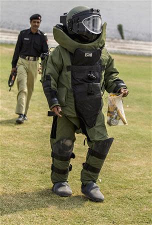 A technician from Pakistan's top bomb disposal unit walks after a demonstration at the unit's headquarters in Peshawar September 12, 2013. REUTERS/Zohra Bensemra