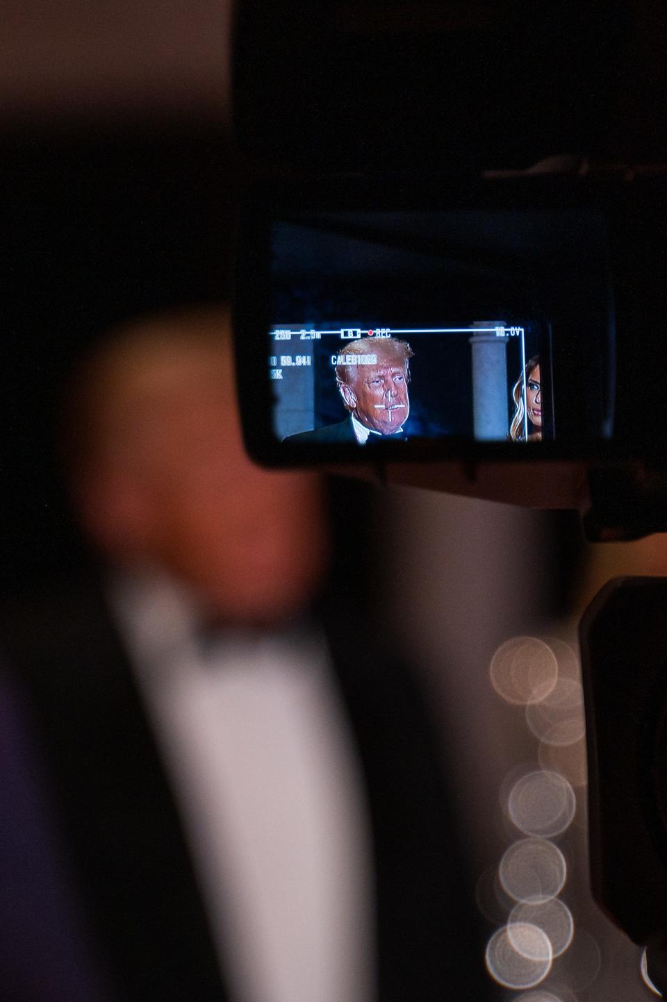 Former President Donald Trump is seen through a TV camera viewfinder while speaking to the media at Mar-A-Lago on New Year's Eve.