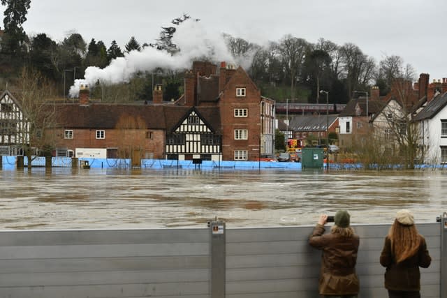 Steam train passes river