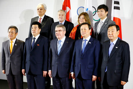 International Olympic Committee (IOC) President Thomas Bach(C), the National Olympic Committee (NOC) of the Republic of Korea (ROK), the NOC of the Democratic People’s Republic of Korea (DPRK), and a delegation from the PyeongChang 2018 Organising Committee (POCOG) pose for a group photo at the IOC headquarters in Lausanne, Switzerland, January 20, 2018. REUTERS/Pierre Albouy