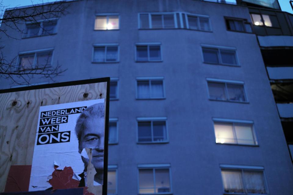 A damaged election poster showing firebrand anti-Islam lawmaker Geert Wilders, is displayed on a billboard in Amsterdam, Netherlands, Monday, March 13, 2017. Wilders' party is campaigning for Wednesday's parliamentary election under the slogan "The Netherlands, Ours Again". (AP Photo/Muhammed Muheisen)