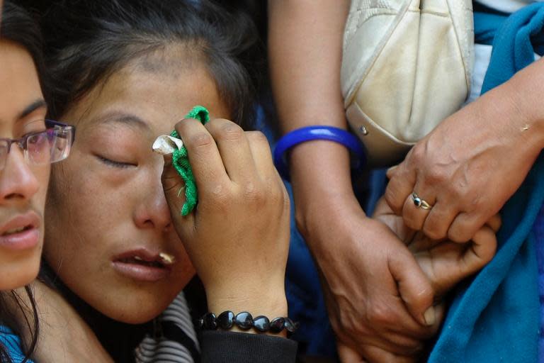 Relatives of a Mount Everest avalanche victim grieve during a cremation ceremony in Kathmandu on April 21, 2014