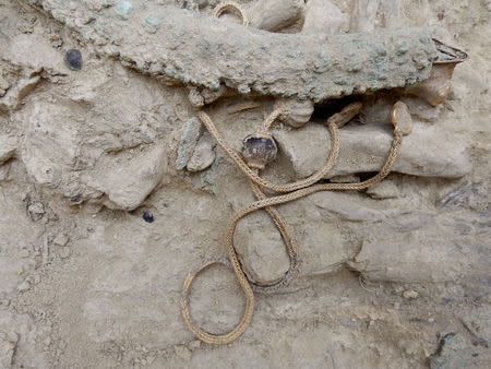 A golden chain is seen inside an ancient tomb, dated circa 1500 B.C in the southeastern city of Pylos, Greece, in this handout picture provided by the Greek Culture Ministry, October 26, 2015. REUTERS/Greek Culture Ministry/Handout via Reuters
