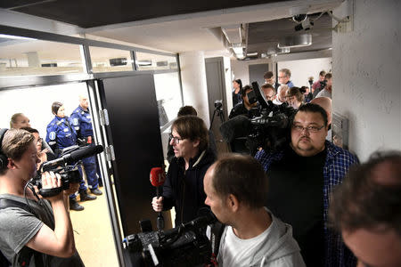 Press and and police pictured before the initial remand hearing of Abderrahman Mechkah (lying in a hospital bed, attending the court session via video), 18 year-old Moroccan man suspected of killing two people and attempting to kill eight others with terrorist intent in Turku, on Friday, August 19, is held at Southwest Finland District Court in Turku, Finland, August 22, 2017. LEHTIKUVA /Martti Kainulainen via REUTERS