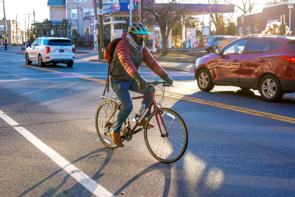 Reporter Wheeler Cowperthwaite bikes down Taunton Avenue in East Providence at the outset of the race.