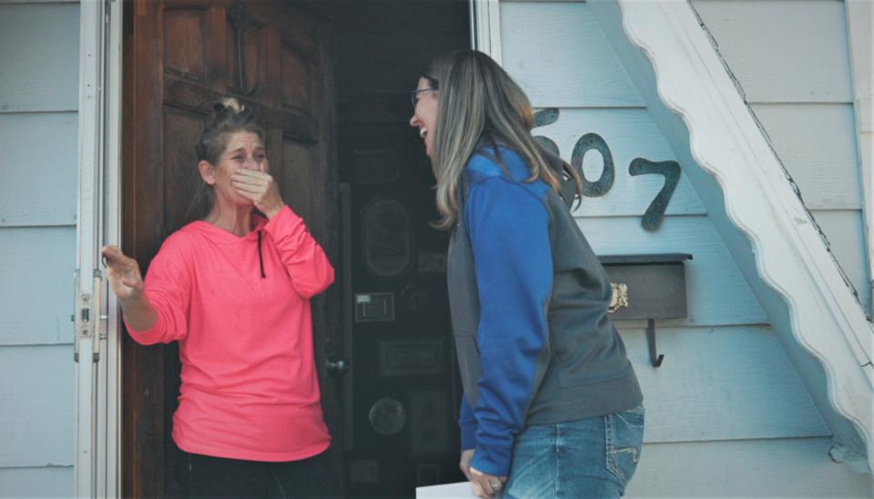 A San Juan County homeowner reacts after being told by Michelle Robbins of Robbins Heating & Air Conditioning Inc. that she and her family would receive a new furnace.