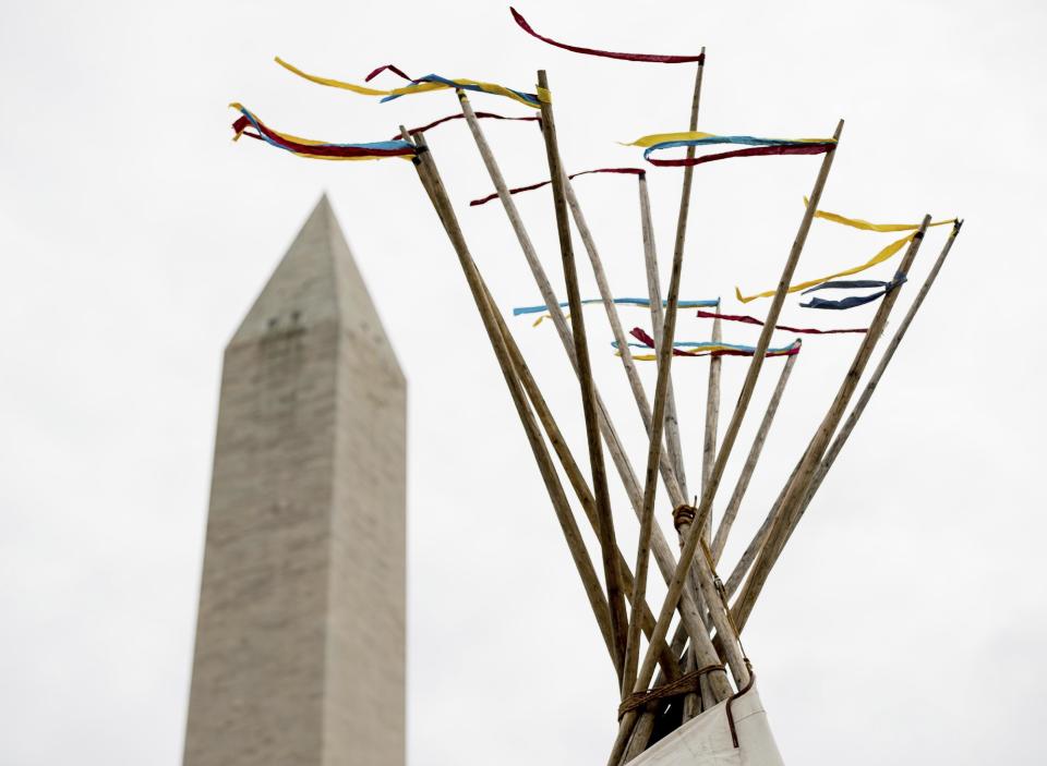 A group protesting the Dakota Access oil pipeline has set up teepees on the National Mall near the Washington Monument in Washington, Tuesday, March 7, 2017. A federal judge declined to temporarily stop construction of the final section of the disputed Dakota Access oil pipeline, clearing the way for oil to flow as soon as next week. (AP Photo/Andrew Harnik)