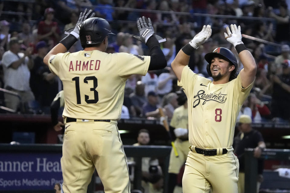 Arizona Diamondbacks' Dominic Fletcher (8) celebrates with teammate Nick Ahmed (13) after hitting a three-run home run against the San Francisco Giants in the second inning during a baseball game, Friday, May 12, 2023, in Phoenix. (AP Photo/Rick Scuteri)