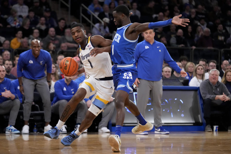Marquette's Kam Jones, left, drives against Xavier's Souley Boum, right, in the first half of an NCAA college basketball game for the championship of the Big East men's tournament, Saturday, March 11, 2023, in New York. (AP Photo/John Minchillo)