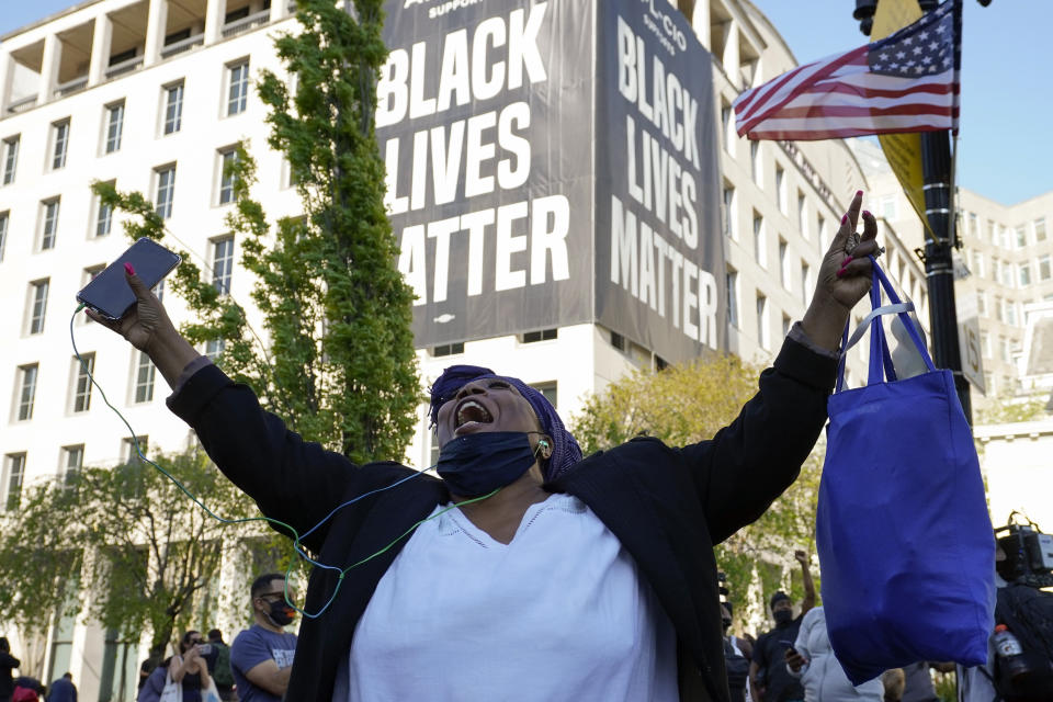 Lisa Robinson of Washington, reacts on Tuesday, April 20, 2021, in Washington, as the guilty verdict in Minneapolis, in the murder trial against former Minneapolis police officer Derek Chauvin was announced. (AP Photo/Alex Brandon)