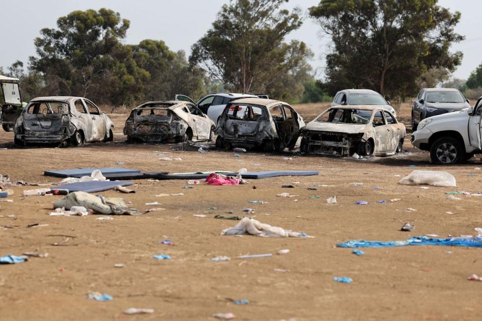 Burnt cars were left behind at the site of the weekend attack on the Supernova desert music Festival by Palestinian militants from the Hamas, near Kibbutz Reim in the Negev desert in southern Israel, on Oct. 10, 2023. (JACK GUEZ/AFP via Getty Images)