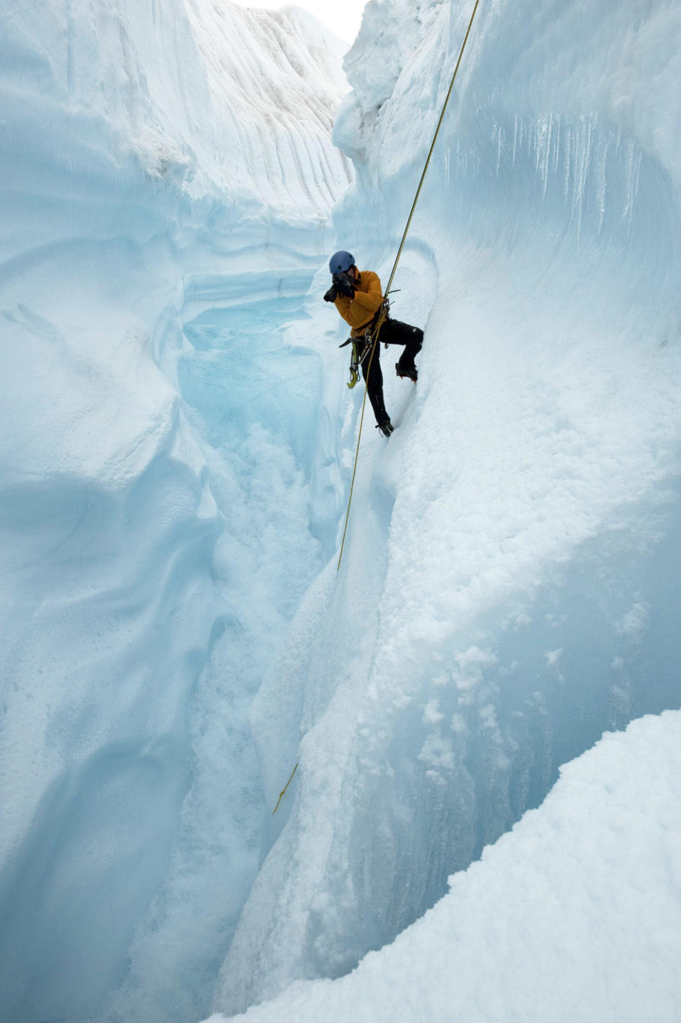 This 2009 photo released by Extreme Ice Survey shows photographer James Balog rappelling into Survey Canyon in Greenland during the filming of "Chasing Ice." The film, about climate change, follows Balog across the Arctic as he deploys revolutionary time-lapse cameras designed to capture a multi-year record of the world's changing glaciers. (AP Photo/Extreme Ice Survey, Jeff Orlowski)