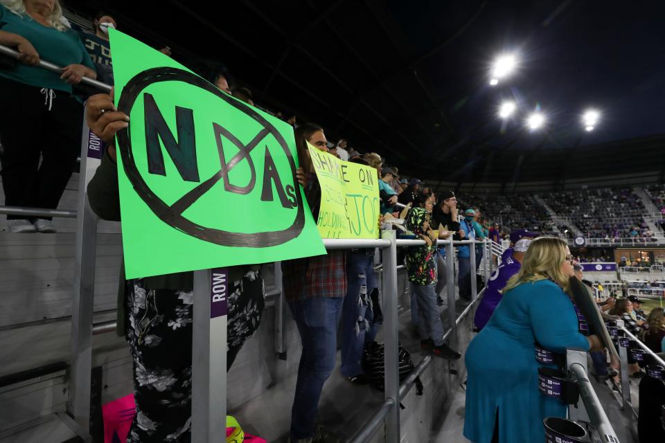 Racing Louisville FC fans held protest signs during the Louisville City FC match against Detroit City FC at the Lynn Family Stadium in Louisville, Ky. on Oct. 5, 2022.  They were supporting the players on the Racing Louisville FC team after allegations that a former coach abused players.