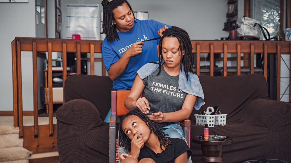 All three of Tonya's children — pictured here, Tonya with her daughters Briana and Grace — wear their hair in braids and locs. - Tomesha Faxio