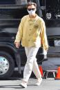 <p>Harry Styles steps out in a yellow shirt as he strolls to the set of <i>Don’t Worry Darling</i> in L.A. on Wednesday. </p>