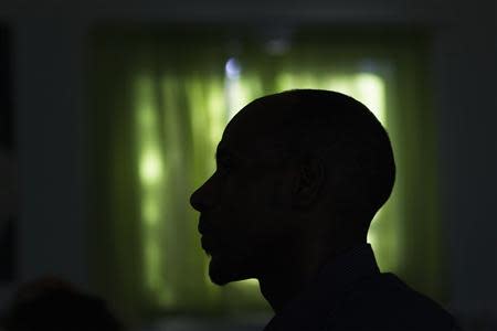 Angesom Solomon, a 28-year-old African migrant from Eritrea, is silhouetted as he attends a first-grade Hebrew lesson at Kehila Democratic school in Tel Aviv, where he also works as a school custodian, November 27, 2013. REUTERS/Ronen Zvulun