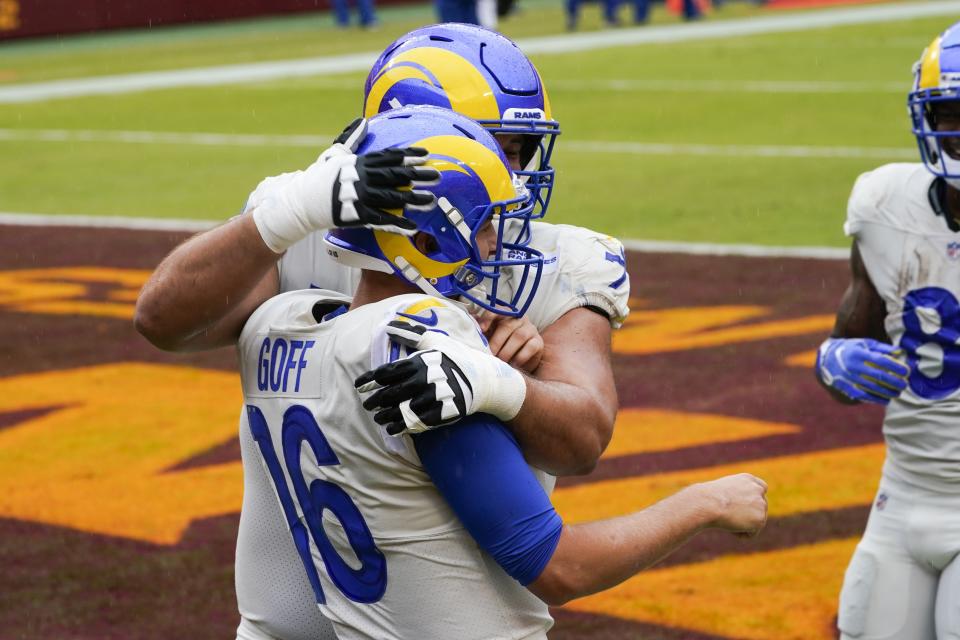 Los Angeles Rams' Jared Goff celebrates his touchdown run with teammate Rob Havenstein during the first half of an NFL football game against the Washington Football Team Sunday, Oct. 11, 2020, in Landover, Md. (AP Photo/Steve Helber)