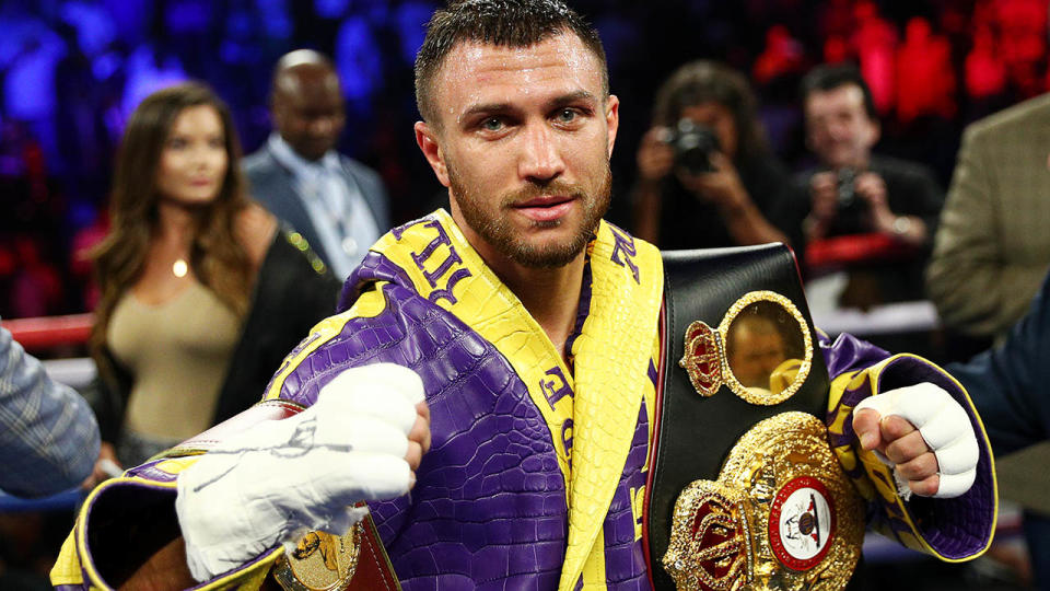 Vasiliy Lomachenko celebrates defending his WBA/WBO lightweight titles. (Photo by Yong Teck Lim/Getty Images)