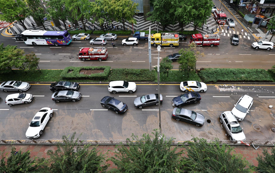 Cars damaged by flood water are seen on the street after heavy rainfall at Gangnam district in Seoul on August 9, 2022.