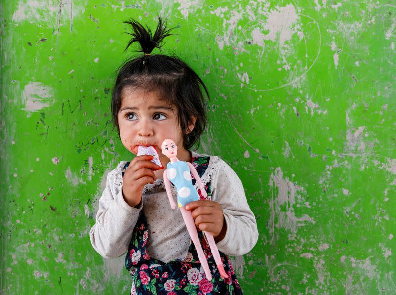 FILE PHOTO: An internally displaced Afghan girl plays outside her shelter, amid the spread of the coronavirus disease (COVID-19), in Kabul, Afghanistan