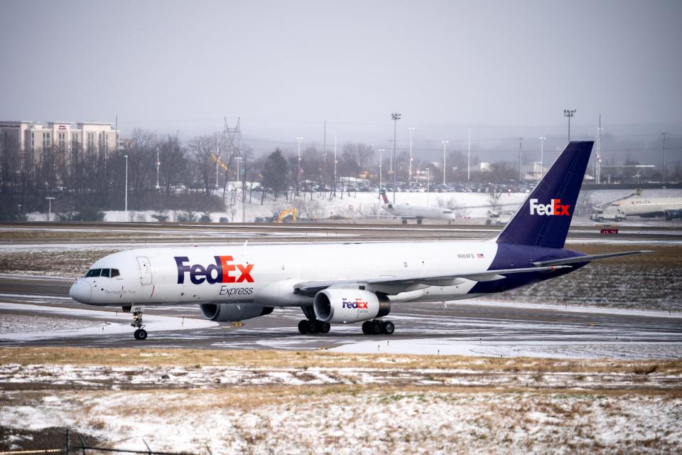 A FedEx flight taxis at Nashville International Airport in Nashville, Tenn., Friday, Dec. 23, 2022. Temperatures dropped overnight turning rain into snow across Nashville and Middle Tennessee.