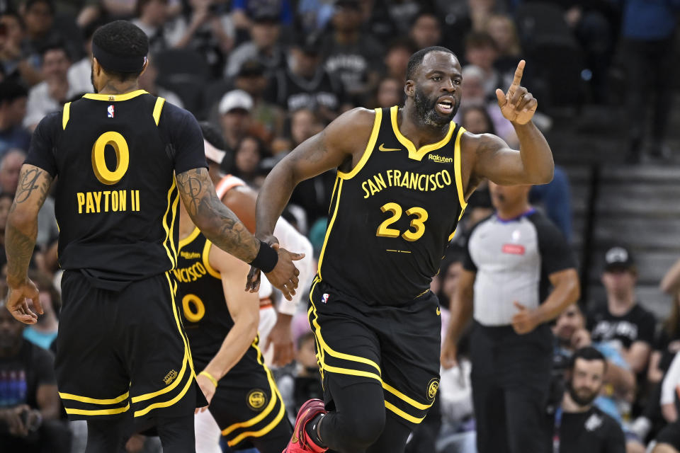 Golden State Warriors' Draymond Green (23) celebrates a basket with Gary Payton II during the first half of the team's NBA basketball game against the San Antonio Spurs, Sunday, March 31, 2024, in San Antonio. (AP Photo/Darren Abate)