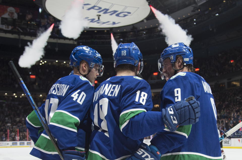 Vancouver Canucks right wing Jake Virtanen (18) celebrates his goal against the Arizona Coyotes with teammates Elias Pettersson (40) and J.T. Miller (9) during the second period of an NHL hockey game Thursday, Jan. 16, 2020, in Vancouver, British Columbia. (Jonathan Hayward/The Canadian Press via AP)