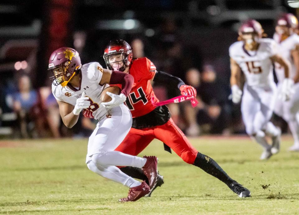 Salpointe Catholic middle linebacker Nathan Spivey (8) runs with the ball against Liberty wide receiver Braylon Gardner (14) at Liberty High School's football field in Peoria on Oct. 13, 2023.