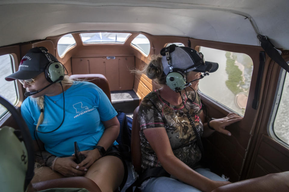 Jessica McCain, of the United Cajun Navy, and volunteer Sunshine Jacobs, of Rayne, La., help search for debris in the marsh from a seaplane as the search continues for 7 missing Seacor Power crew members, near Lake Pelto in Terrebonne Parish, La., Thursday, April 29, 2021. (Sophia Germer/The Advocate via AP)