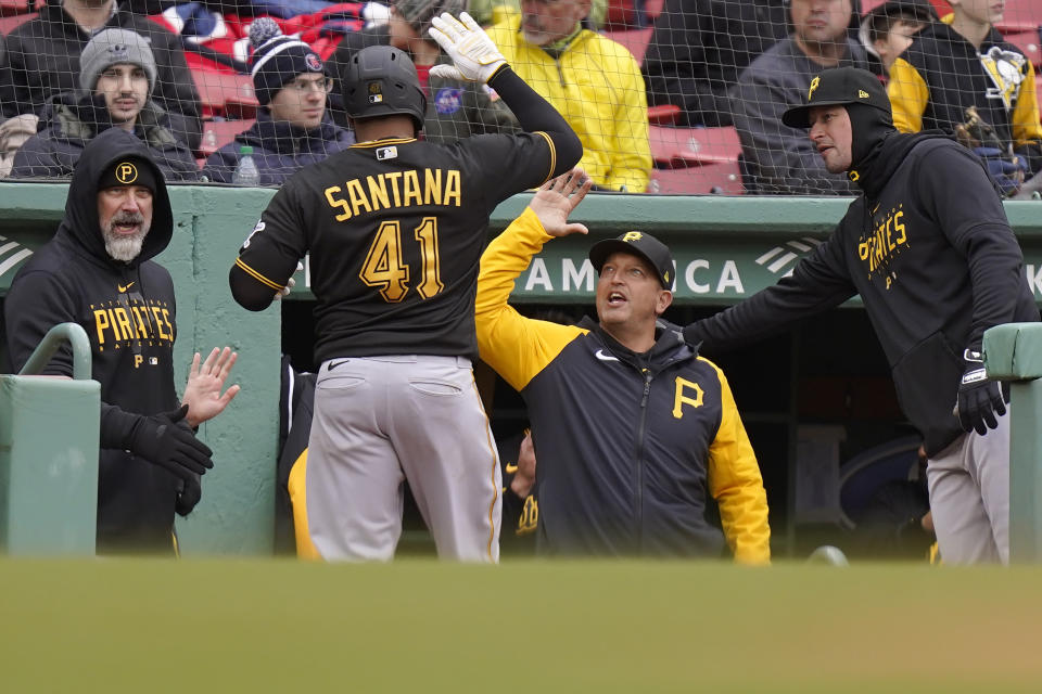 Pittsburgh Pirates' Carlos Santana (41) is greeted at the dugout after hitting a home run in the fourth inning of a baseball game against the Boston Red Sox, Wednesday, April 5, 2023, in Boston. (AP Photo/Steven Senne)