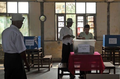 Voters cast their ballot papers during parliamentary by-elections at a polling station in Kawhmu on April 1. As a taboo on Myanmar political discussion wanes, pollsters are stepping up to take the pulse of the nation