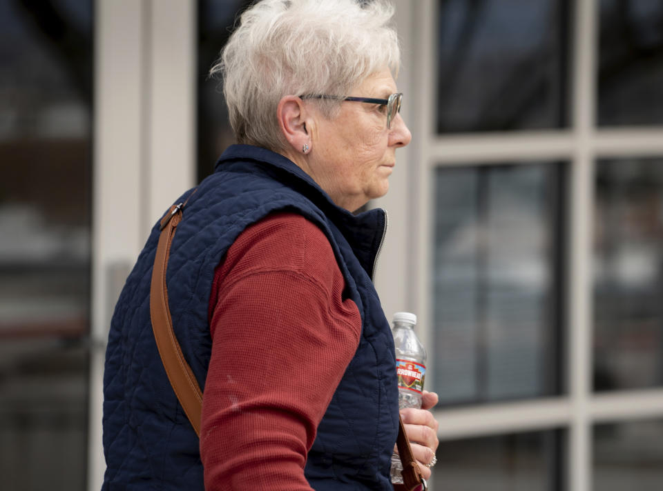 Wanda Kelly, George Alan Kelly's wife, leaves Nogales Justice Court, Nogales, Ariz., after his preliminary hearing on Wednesday, Feb. 22, 2023. George Alan Kelly, faces a first-degree murder charge in the fatal shooting of Gabriel Cuen-Butimea, who lived just south of the border in Nogales, Mexico. (Mark Henle/The Arizona Republic via AP, Pool)