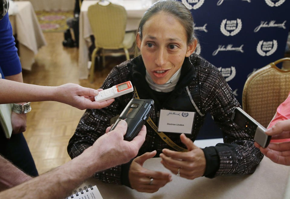 Boston Marathon runner Desiree Linden answers a reporter's question during a media availability of Boston Marathon elite runners at the Copley Plaza Hotel in Boston Friday April 18, 2014. The 118th running of the Boston Marathon is Monday April 21, 2014. (AP Photo/Stephan Savoia)