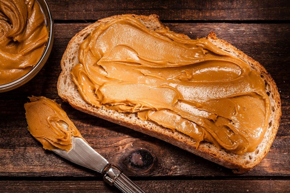 Toast with peanut butter shot on rustic wooden table