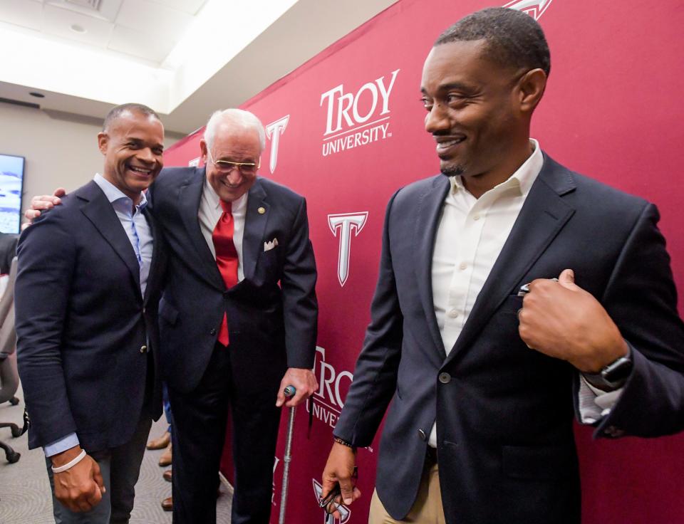 Valiant Cross Academy’s Fred Brock, left, and Anthony Brock, right, chat with Troy University Chancellor Jack Hawkins, center, as Troy transfers the deed to a building on their Montgomery campus to Valiant Cross Academy on Tuesday, June 27, 2023.