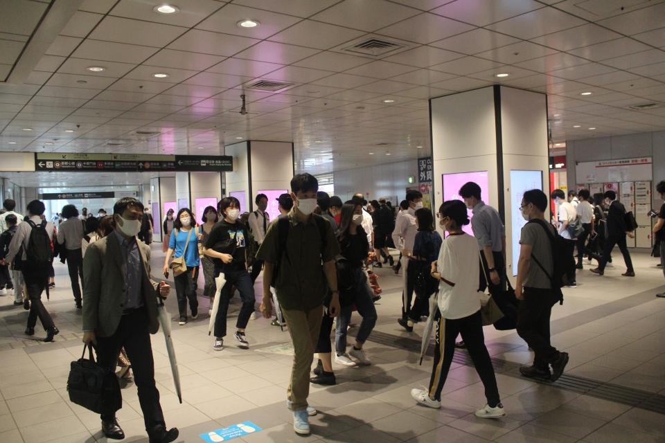 Crowds of people at Shibuya Station in Tokyo.