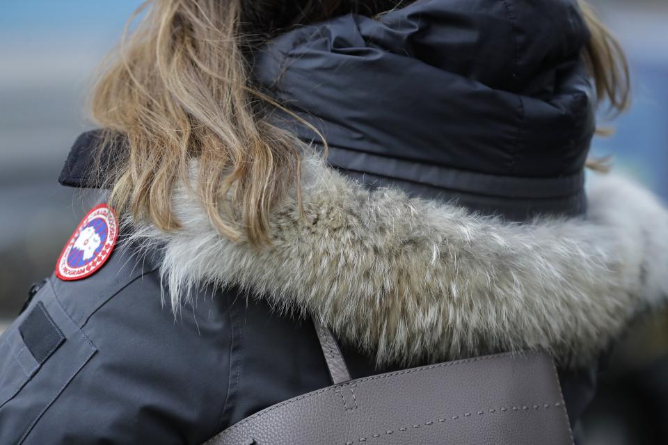 In this Feb. 14, 2019 photo, a woman in New York wears a Canada Goose coat with a hood fur trimmed with coyote fur. Coyote pelts are in big demand to provide the lush, tawny-tinged arc of fur on the hoods on Canada Goose coats and their many global imitators. Canada Goose parkas are credited with the uptick in demand for coyote fur. (AP Photo/Frank Franklin II)