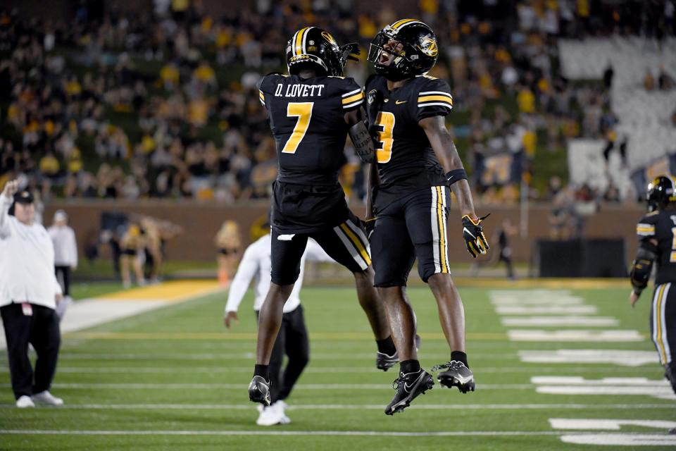 Missouri wide receiver Luther Burden III, right, is congratulated by teammate Dominic Lovett (7) after scoring during the first half of an NCAA college football game against Louisiana Tech Thursday, Sept. 1, in Columbia, Mo.