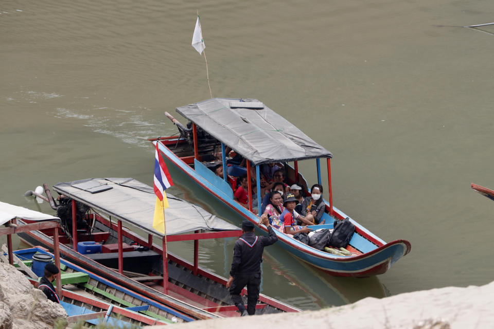 FILE - In this March 30, 2021, file photo, Karenni villagers from Myanmar arrive on a boat with an injured person as they evacuate to Ban Mae Sam Laep Health Center in Mae Hong Son province, northern Thailand. Far away in Myanmar’s borderlands, millions of others who hail from Myanmar’s minority ethnic groups are facing increasing uncertainty and waning security as longstanding conflicts between the military and minority guerrilla armies flare anew. (AP Photo/Sakchai Lalit, File)