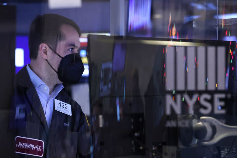 A trader in a face mask works on the trading floor at the New York Stock Exchange (NYSE) in Manhattan, New York City