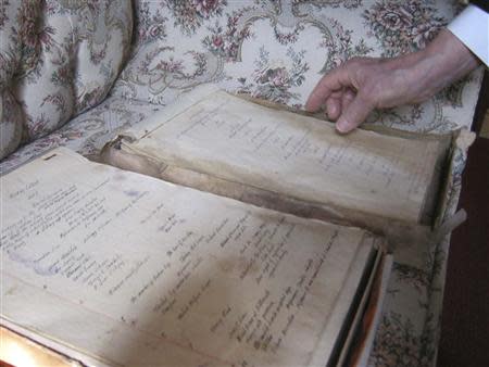 Dudley Martin looks at handwritten manuscripts written by Robert Stroud at his home in Springfield, Missouri, February 12, 2014. REUTERS/Kevin Murphy