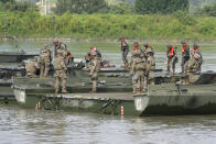 U.S. and South Korean soldiers try to connect a floating bridge during the combined wet gap crossing military drill between South Korea and the United States as a part of the Ulchi Freedom Shield military exercise in Cheorwon, South Korea, Thursday, Aug. 31, 2023. (AP Photo/Lee Jin-man)