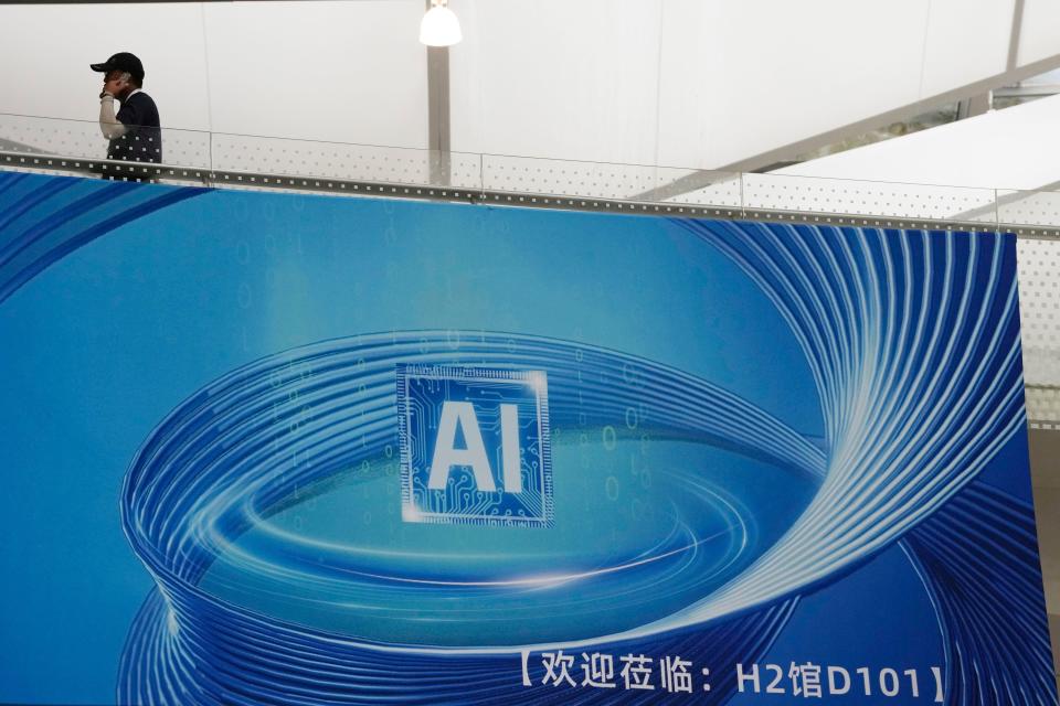 A visitor passed by an ad promoting Artificial Intelligence for the World Artificial Intelligence Conference held in Shanghai, Wednesday, July 5, 2023.